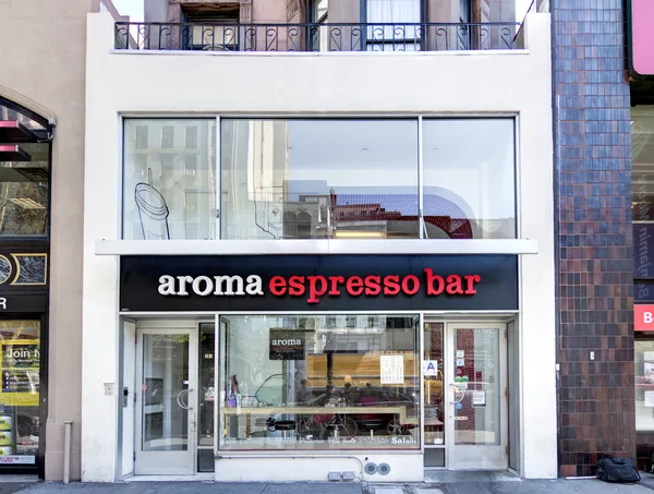 Espresso machine and pastry case at a café counter