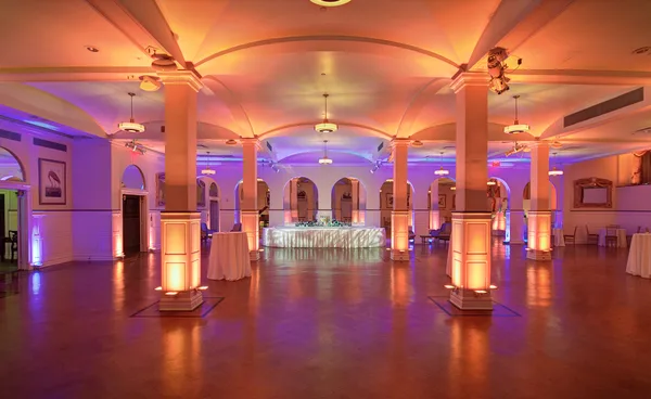 Wide view across an empty venue at full lighting