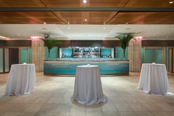 Waterfront event room with tables along the windows