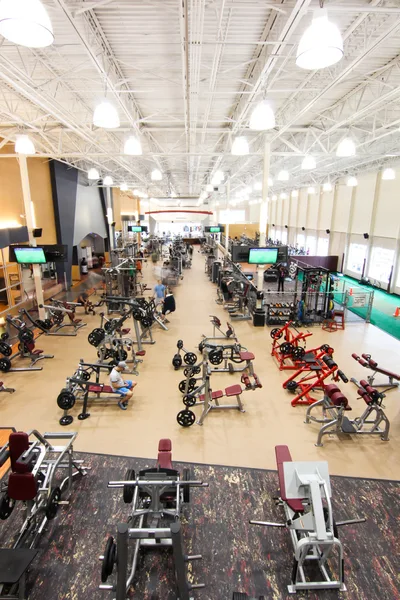 Water station and towels staged along the gym wall