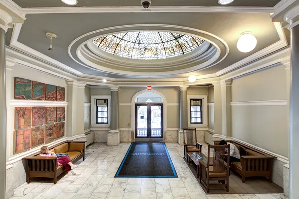 Residence hall corridor with room doors and bulletin boards