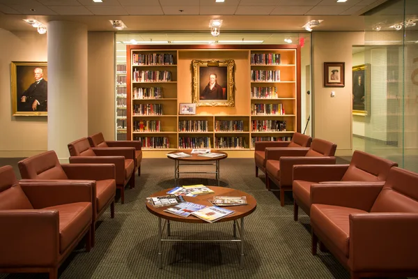 Glass-walled conference room along the office corridor