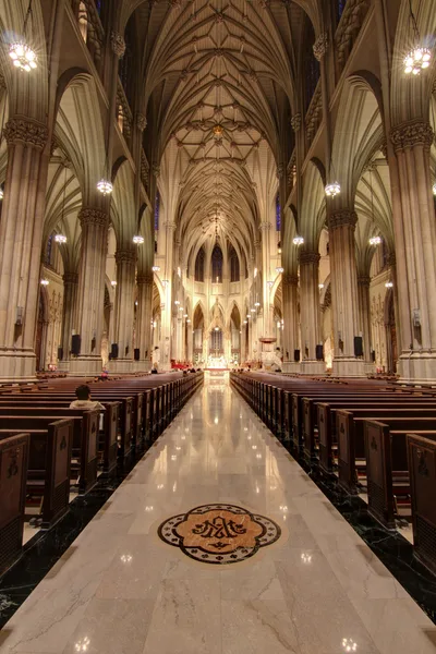 Candle stand with votives lit in a side chapel