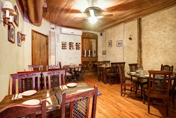 Rustic dining room with exposed brick and wood tables