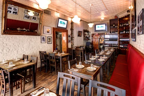 Wine display wall beside restaurant seating