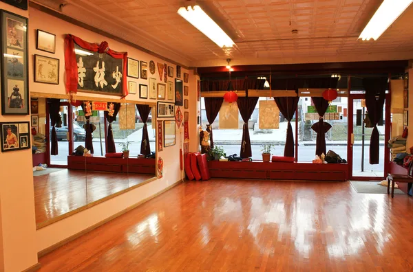 Yoga studio with mats rolled out toward the mirror wall